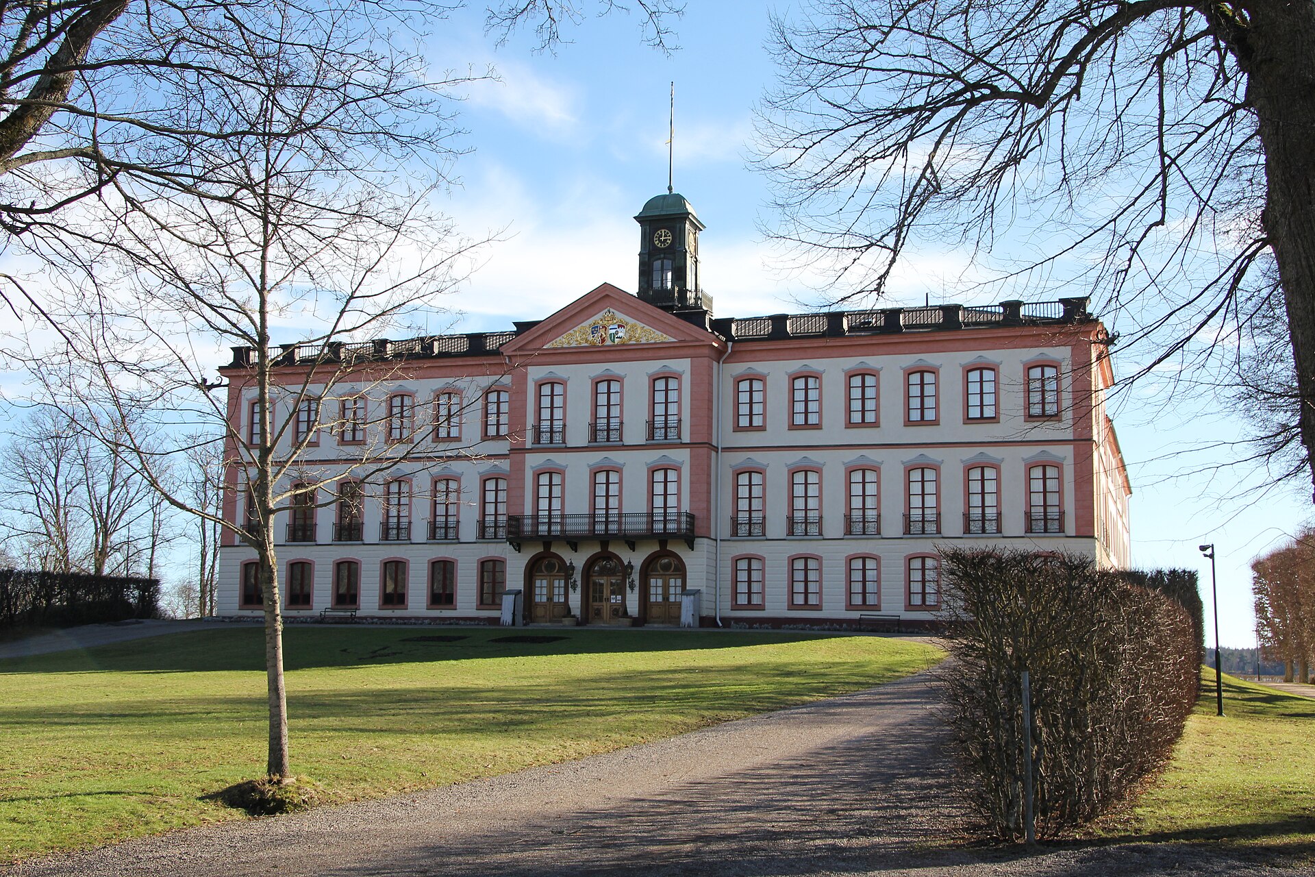 Tullgarns slotts gulvita huvudfasad med rosa omfattningar och klocktorn