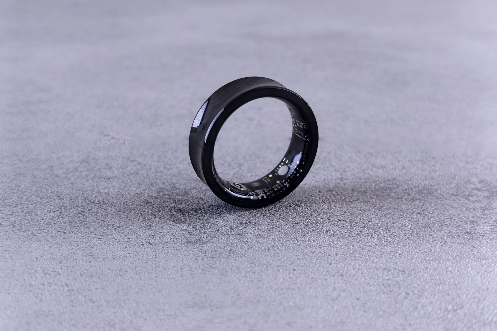 Black smart ring on a grey surface