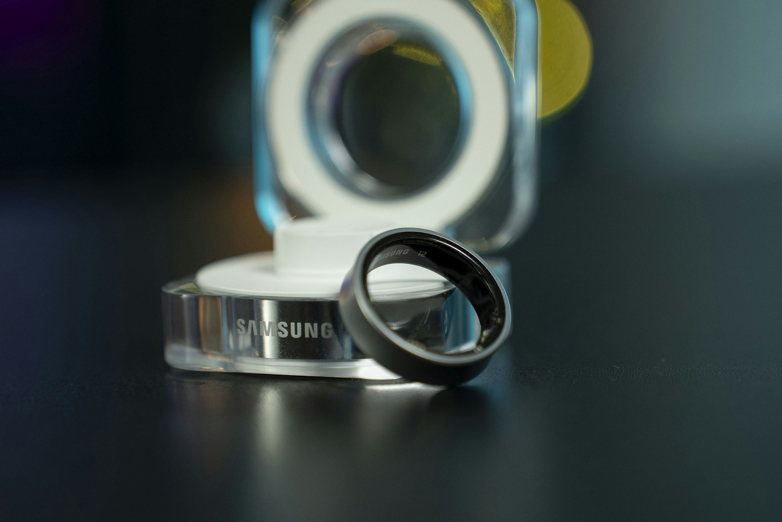 Samsung Galaxy Ring next to its charging case