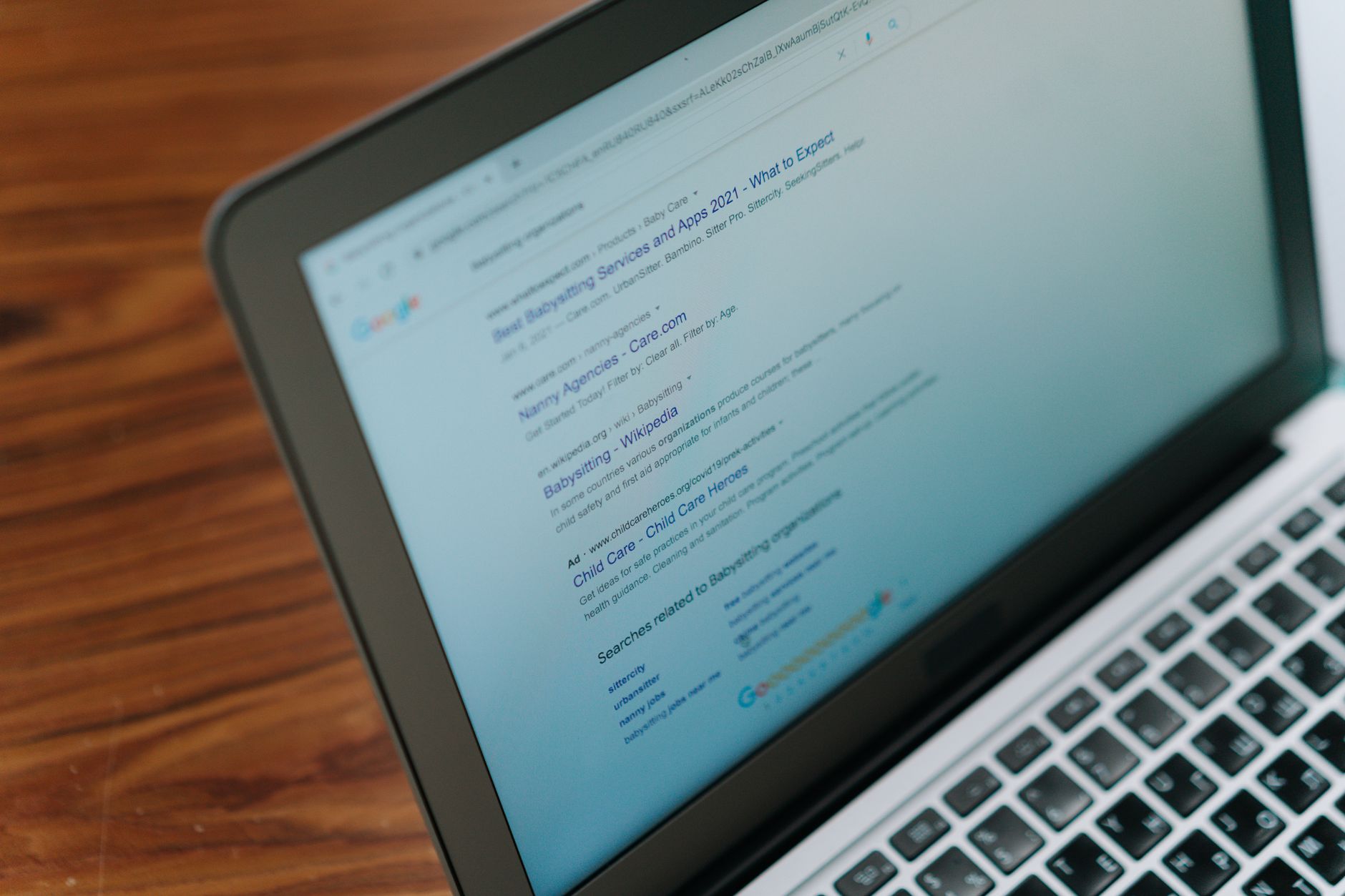 Ett sökresultat på Google med titellänkar och utdrag visas på skärmen till en bärbar dator