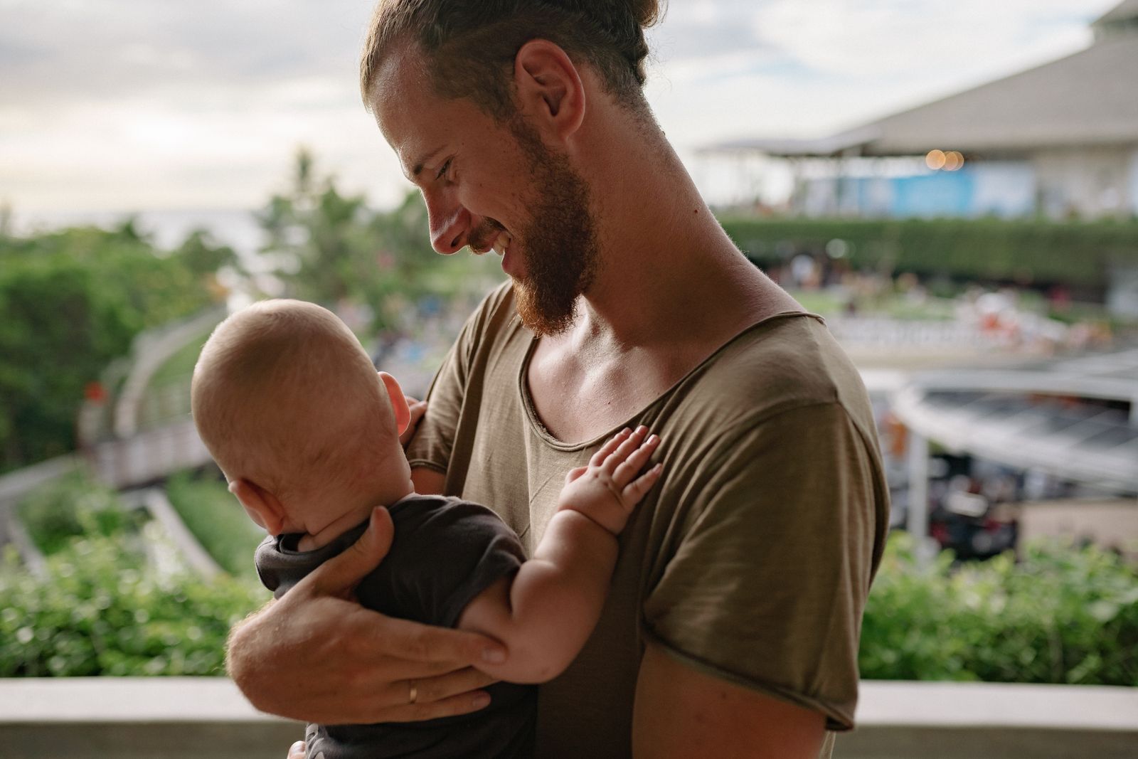 Father holding his baby during parental leave