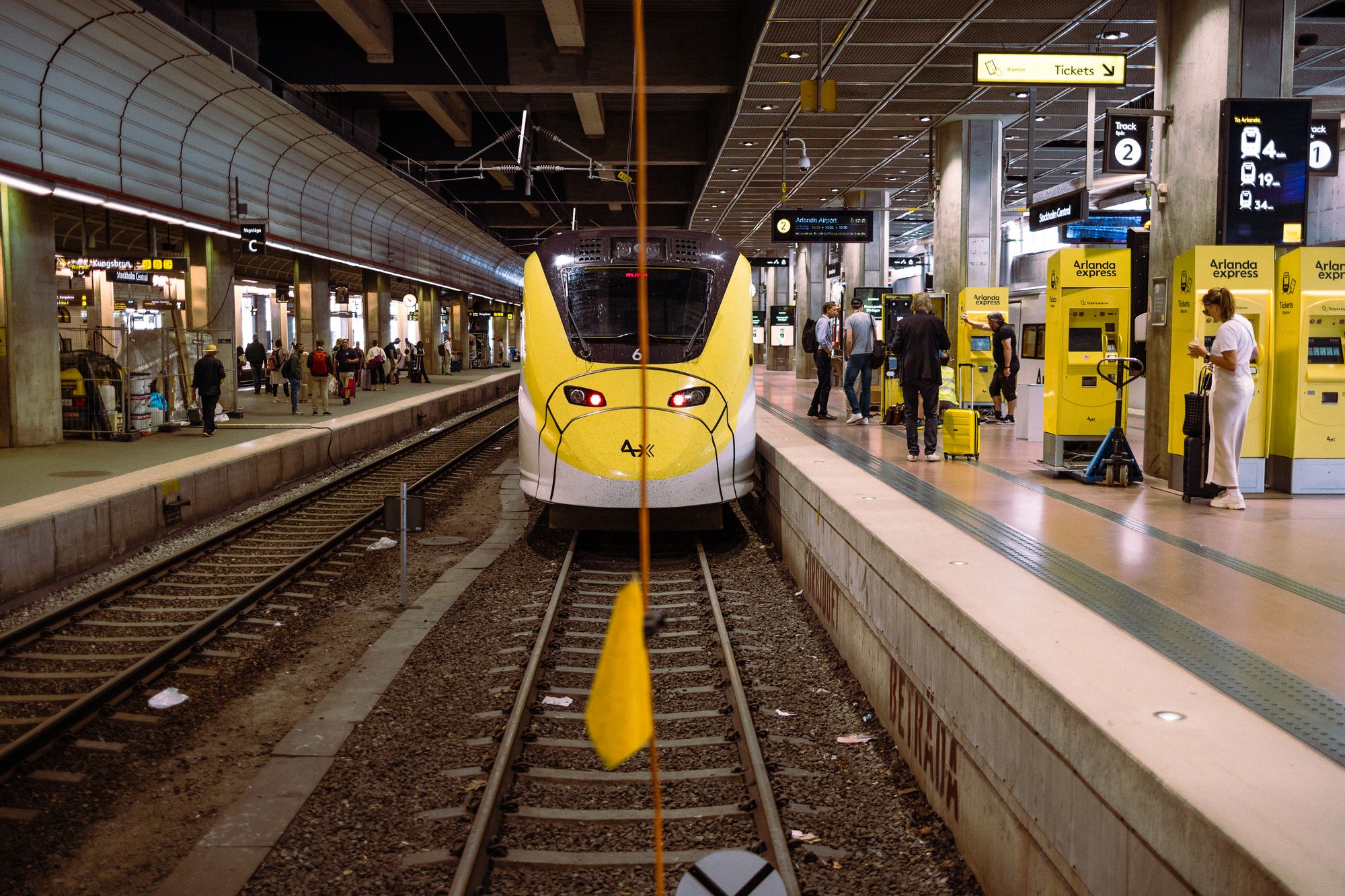 Gult Arlanda Express-tåg vid plattformen på Stockholms centralstation