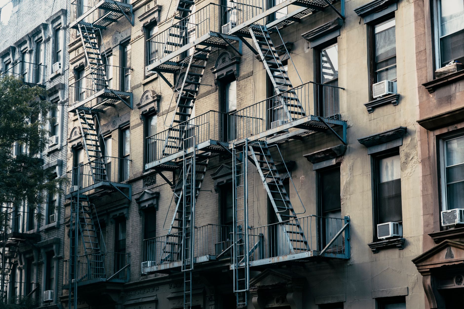 Äldre hyreshus med brandtrappor på fasaden i New York
