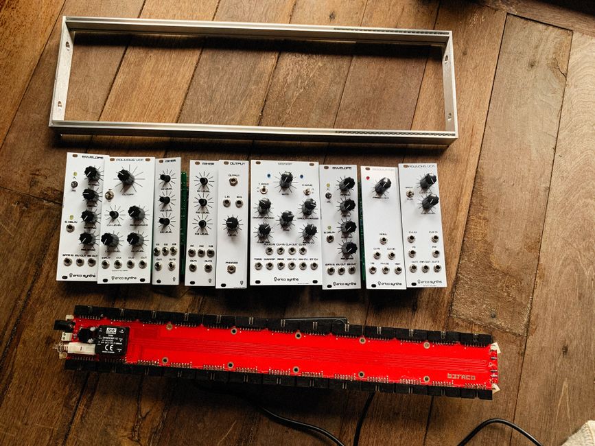 Eurorack modules being assembled into a case with a power supply