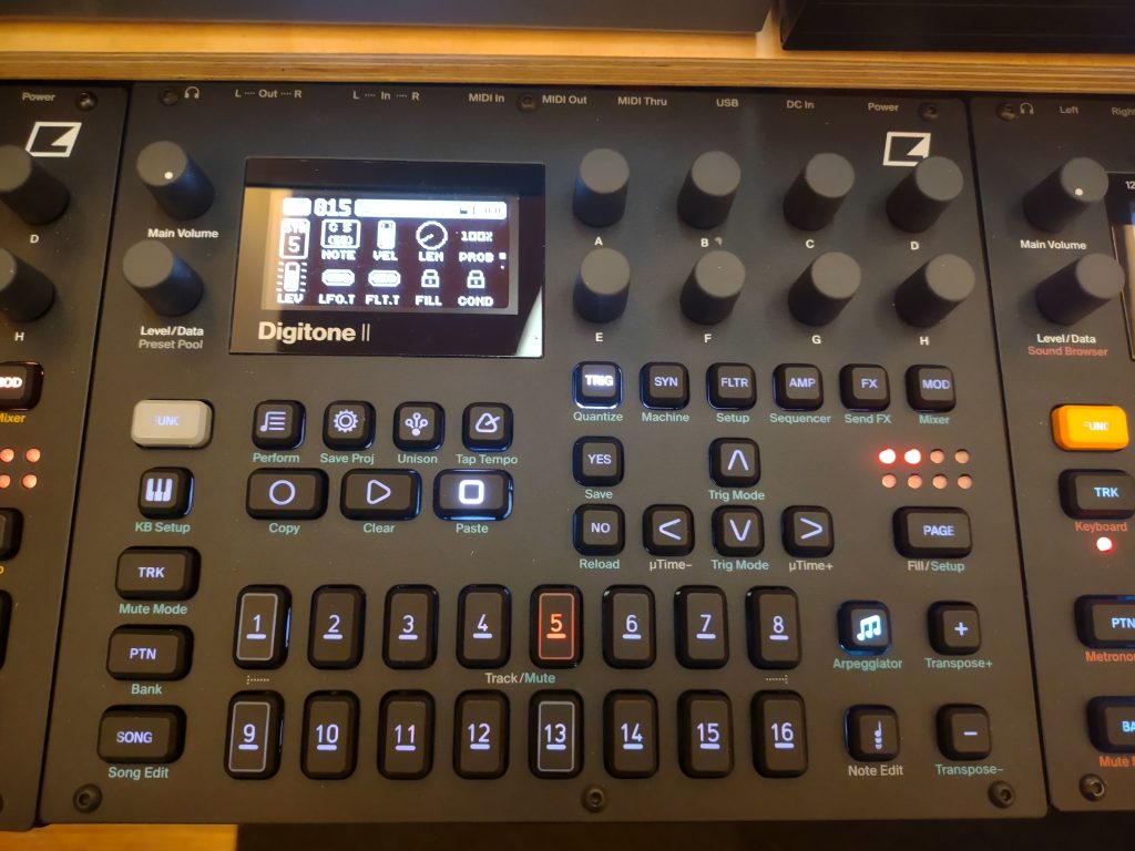 Three Elektron machines side by side with a Digitone II in the middle, rear panel USB port visible