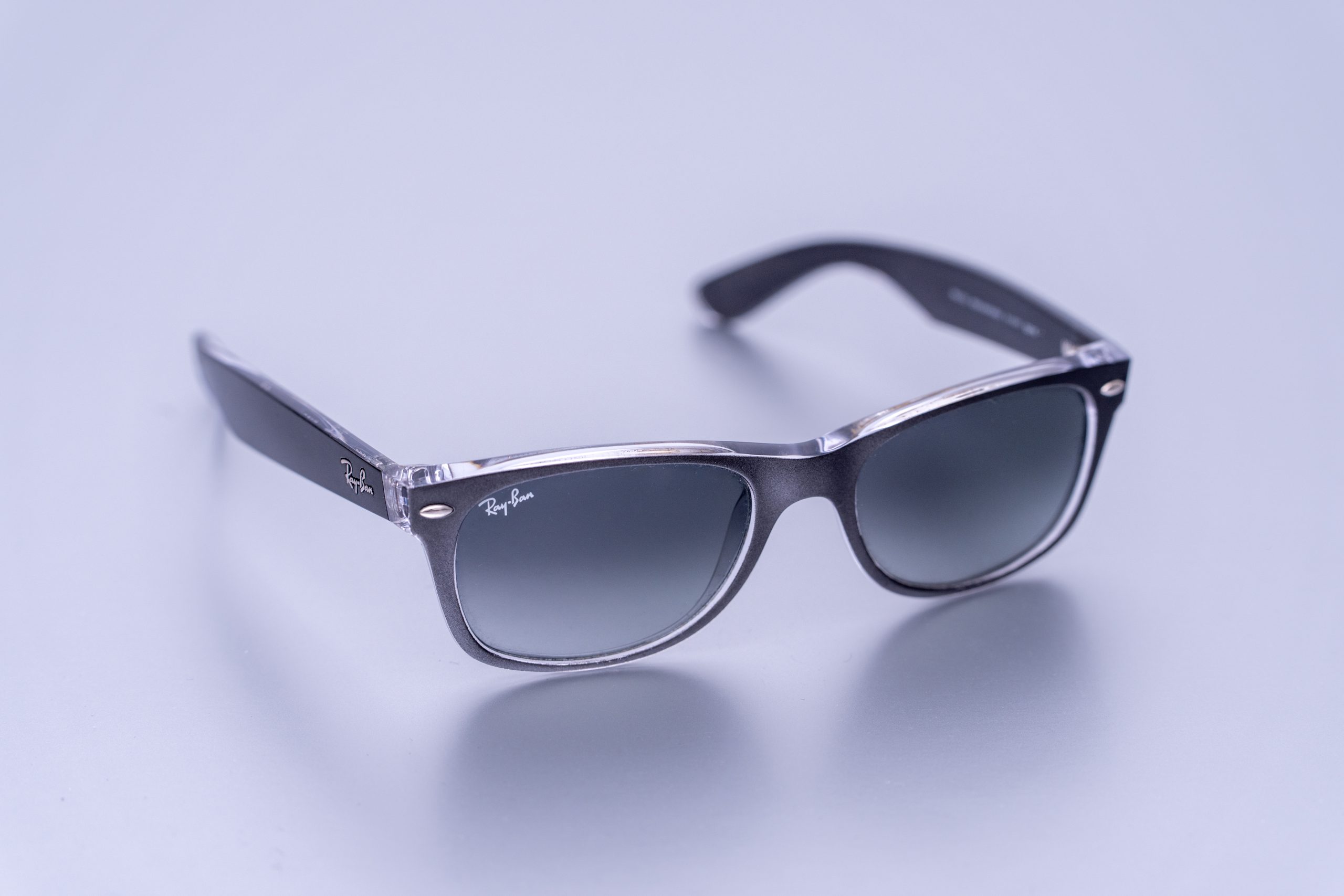 Svart Ray-Ban New Wayfarer solglasögon med gråtonad gradientlins på ljus bakgrund