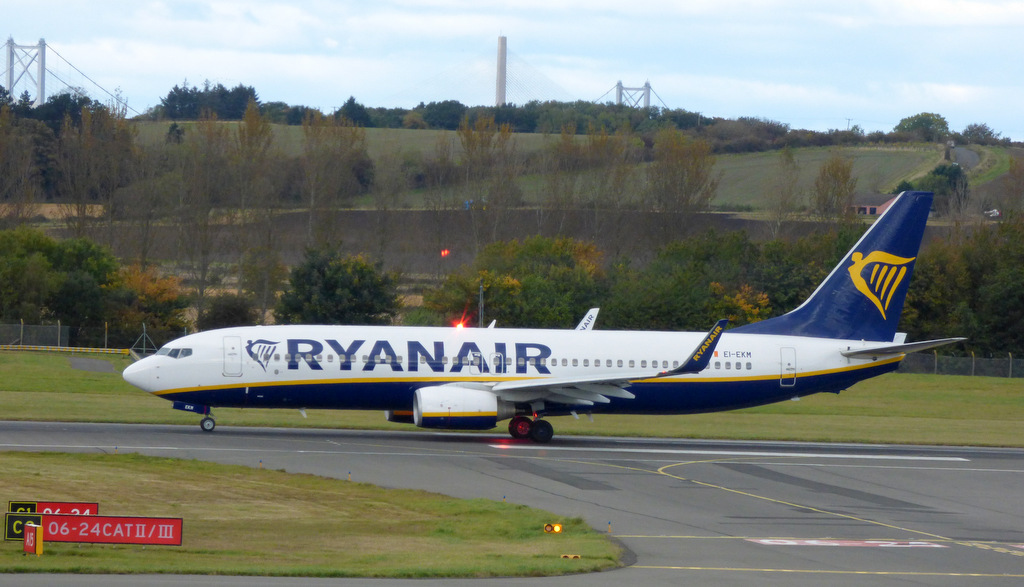 Ryanairflygplan taxar på Edinburghs flygplats med Forthbroarna i bakgrunden