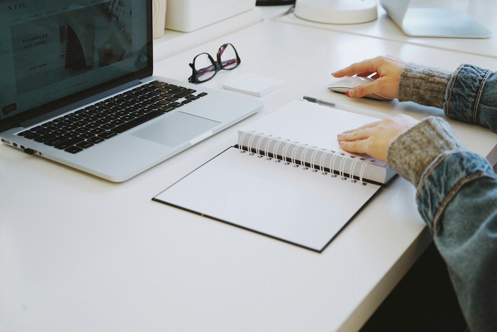 Writing a CV at a desk with a laptop and notebook