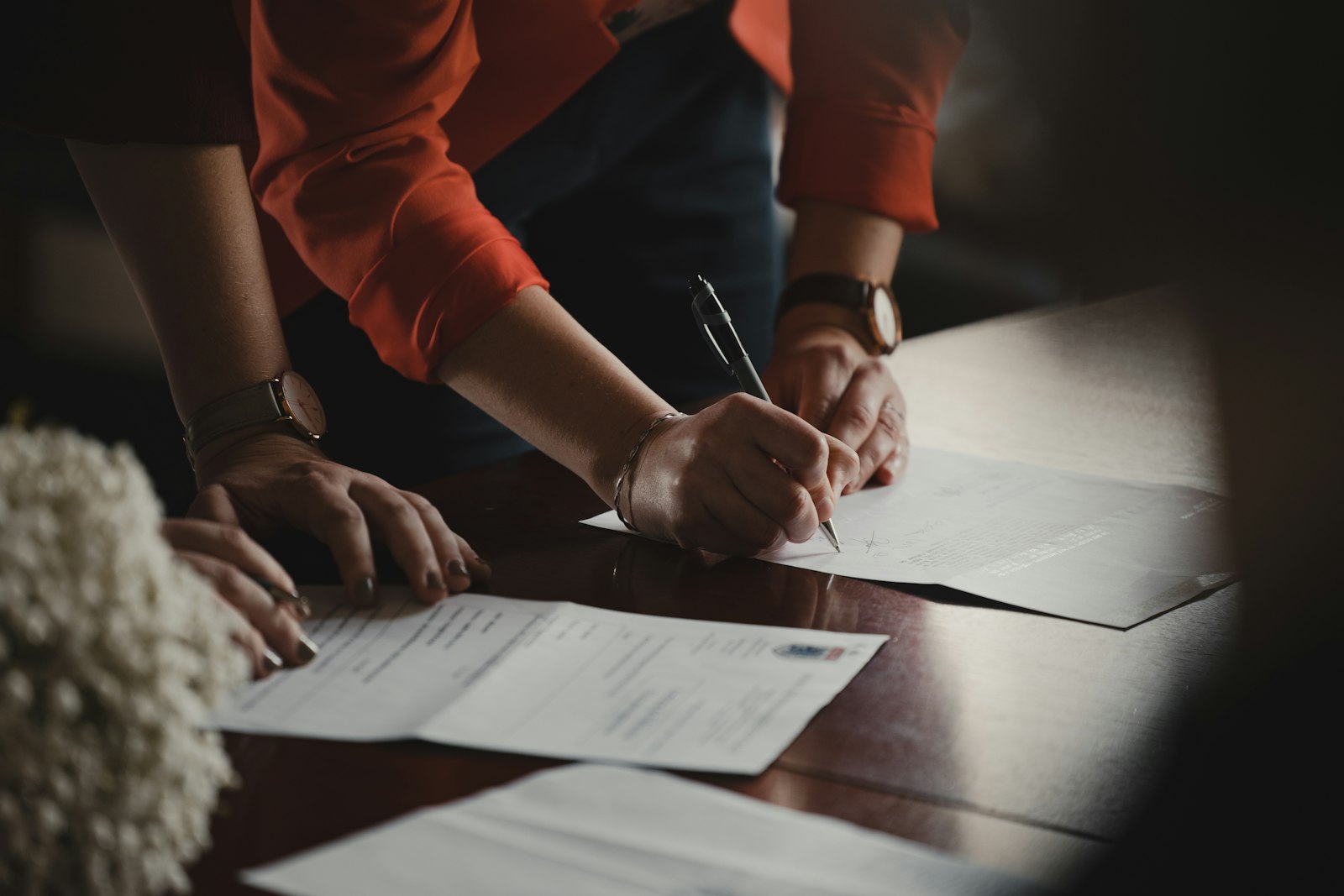 Hands signing a contract with a pen