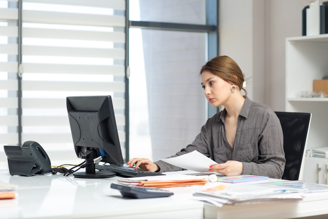 HR professional reviewing employment documents at an office desk
