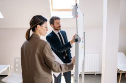 Two colleagues planning at a whiteboard