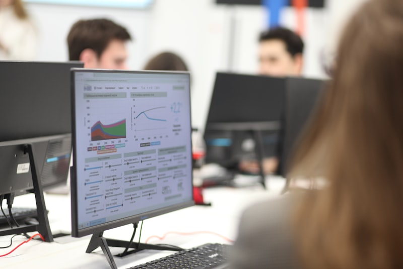 Team monitoring data dashboards on office screens
