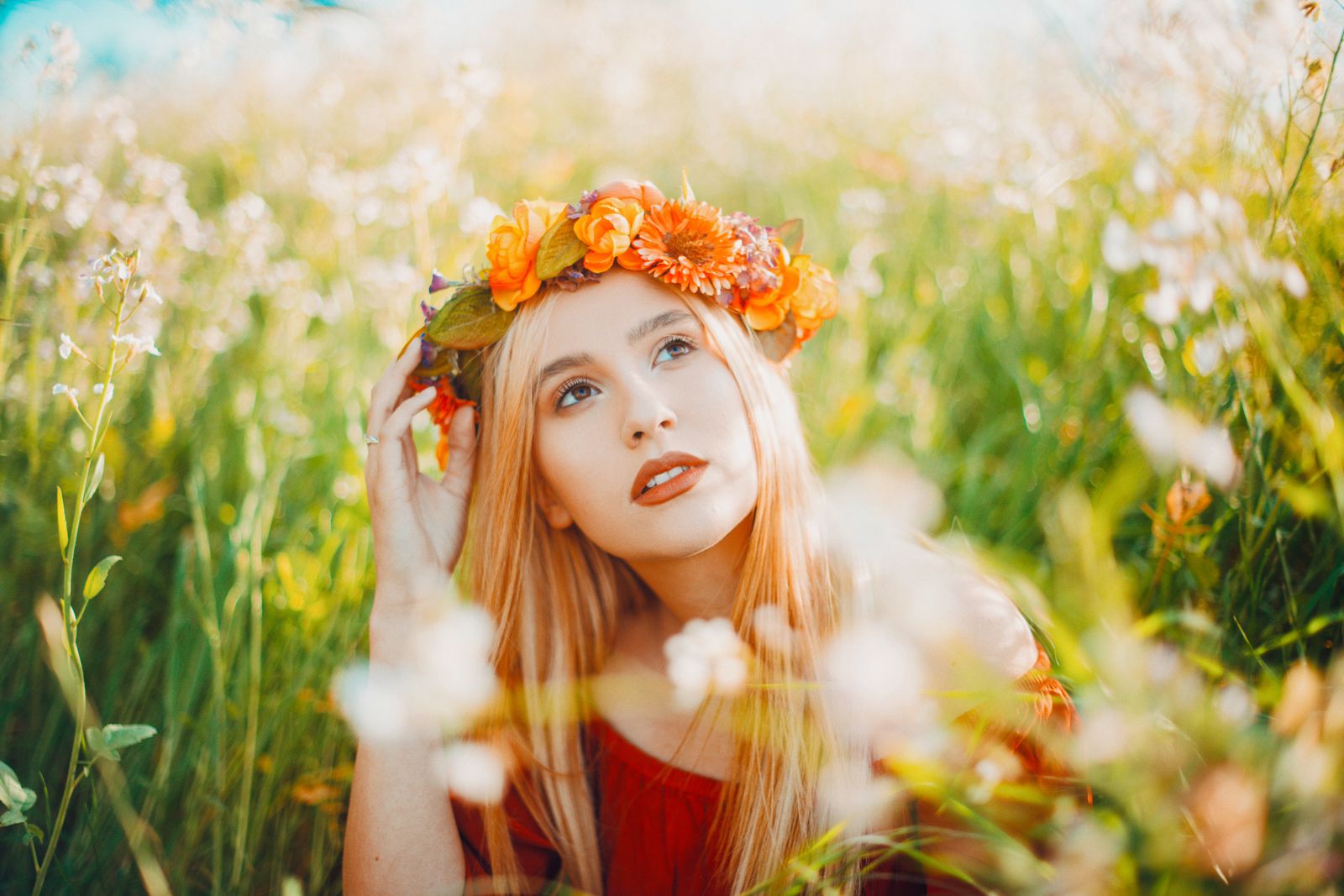 A woman wearing a flower crown in a summer meadow