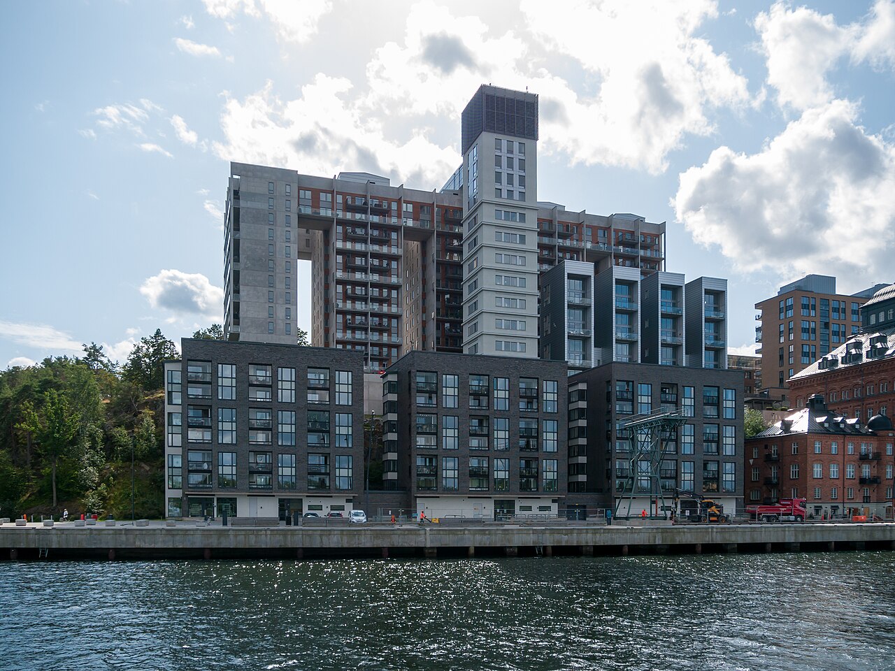 Kvarnholmen i Nacka med gamla silor och bostadshus speglade i vattnet