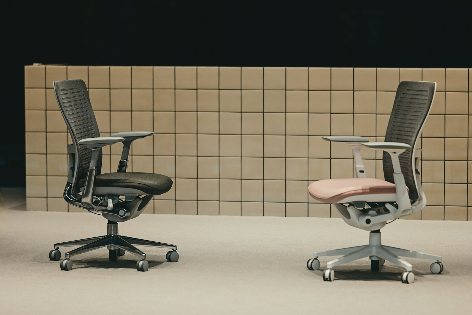 Två ergonomiska kontorsstolar med justerbara armstöd och femarmad hjulbas
