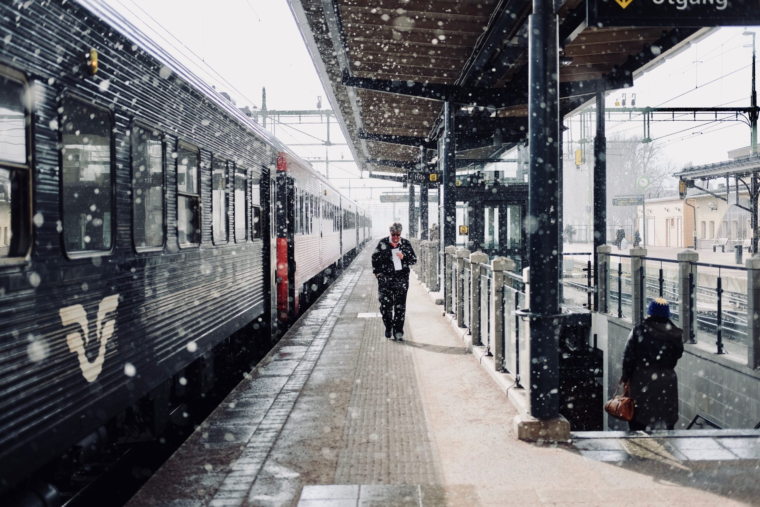 Tåg vid snöig perrong på en svensk station